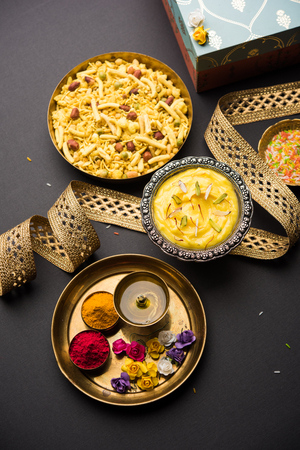 Raksha bandhan Festival : conceptual Rakhi made using Shrikhand in a bowl with band and Pooja Thali. A traditional Indian wrist band which is a symbol of love between Brothers and Sistersの写真素材