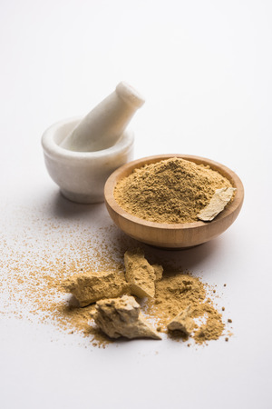 Fuller'S Earth Clay OR Multani mitti in a bowl along with raw stones and mortarの写真素材