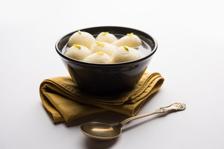 Indian Rasgulla or Rosogulla dessert/sweet served in a bowl. selective focus