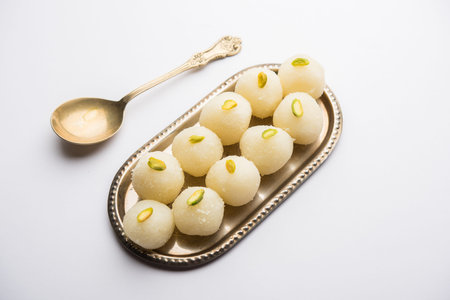 Indian Rasgulla or dry Rosogulla dessert/sweet served in a bowl. selective focus