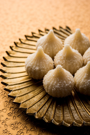 Sweet Modak made using coconut, khoya and sugar. Popular Maharashtrian recipe offered to lord Ganesha in Ganesh Festival. Served in a plate. Selective focusの写真素材