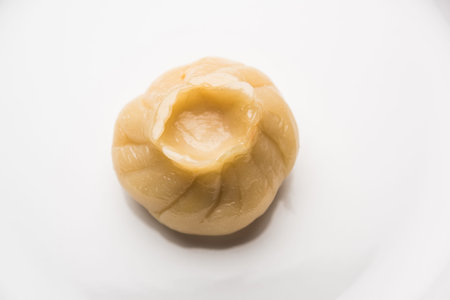 Dumpling momos food from Nepal or Ladakh served with red chilli chutney over moody background....