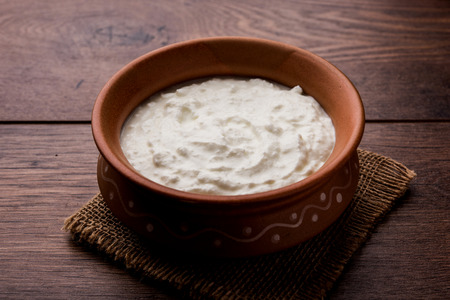 Plain curd or yogurt or Dahi in Hindi, served in a bowl over moody background. Selective focusの写真素材