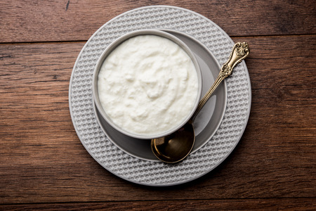 Plain curd or yogurt or Dahi in Hindi, served in a bowl over moody background. Selective focusの写真素材