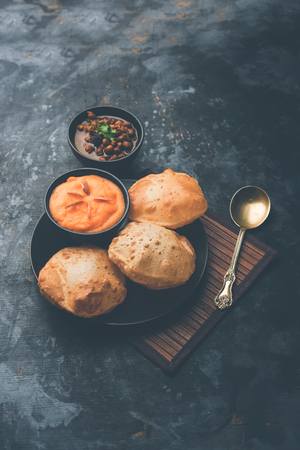 Suji/Sooji Halwa Puri or Shira Poori with black chana masala breakfast, served in a plate and bowl. selective focusの写真素材