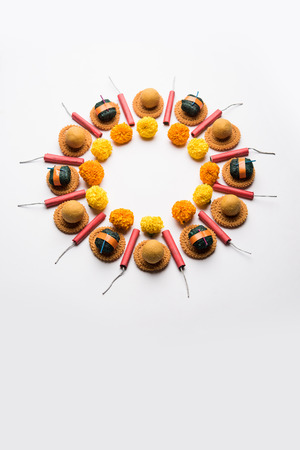 Rangoli or design made using Indian snacks/sweet and firecrackers or patakhe for Diwali festivalの写真素材