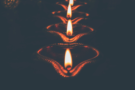 Beautiful diwali diyas at night with flowers, lighting series and gifts, moody backgroundの写真素材