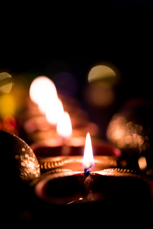 Beautiful diwali diyas at night with flowers, lighting series and gifts, moody backgroundの写真素材