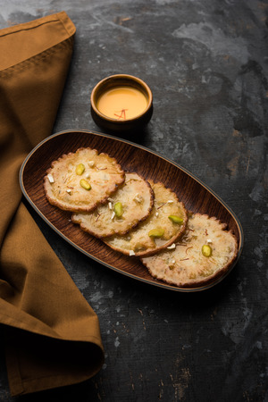 Malpua sweet - Traditional Indian dessert or pancake for festivals, served in plate with rabri/rabdi . selective focusの写真素材