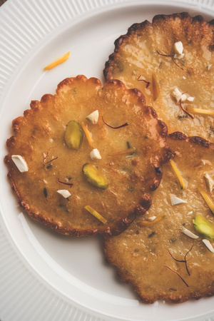 Malpua sweet - Traditional Indian dessert or pancake for festivals, served in plate with rabri/rabdi . selective focusの写真素材