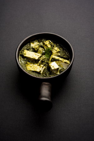 Palak Paneer Curry made up of spinach and cottage cheese served in a bowl or pan with roti or riceの写真素材