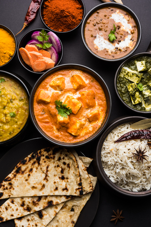 Indian Lunch / Dinner main course food in group includes Paneer Butter Masala, Dal Makhani, Palak Paneer, Roti, Rice etc, Selective focusの写真素材