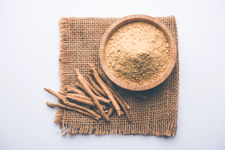 Ashwagandha / Aswaganda OR Indian Ginseng is an Ayurveda medicine in stem and powder form. Isolated on plain background. selective focusの写真素材