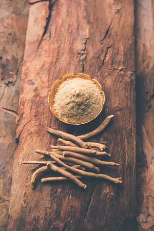 Ashwagandha / Aswaganda OR Indian Ginseng is an Ayurveda medicine in stem and powder form. Isolated on plain background. selective focusの写真素材