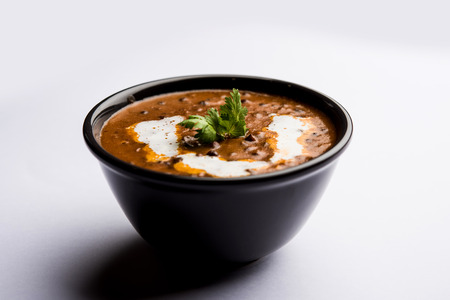 Dal makhani / makhni is a popular dish from India. Made with ingredients like whole black lentil, butter and cream. Served with Naan/roti and riceの写真素材