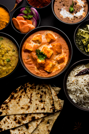 Indian Lunch / Dinner main course food in group includes Paneer Butter Masala, Dal Makhani, Palak Paneer, Roti, Rice etc, Selective focusの写真素材