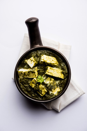 Palak Paneer Curry made up of spinach and cottage cheese served in a bowl or pan with roti or riceの写真素材
