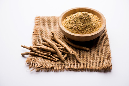 Ashwagandha / Aswaganda OR Indian Ginseng is an Ayurveda medicine in stem and powder form. Isolated on plain background. selective focusの写真素材