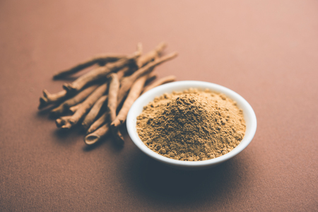 Ashwagandha / Aswaganda OR Indian Ginseng is an Ayurveda medicine in stem and powder form. Isolated on plain background. selective focusの写真素材