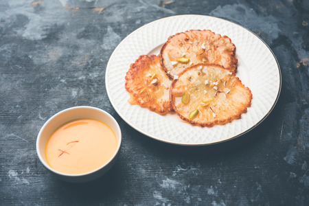 Malpua sweet - Traditional Indian dessert or pancake for festivals, served in plate with rabri/rabdi . selective focusの写真素材