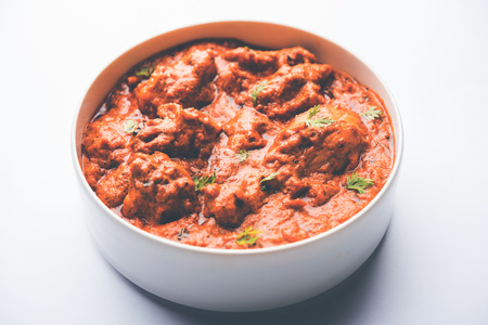 Murgh Makhani / Butter chicken tikka masala served with roti / Paratha and plain rice along with onion salad. selective focusの写真素材