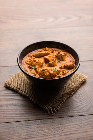 Murgh Makhani / Butter chicken tikka masala served with roti / Paratha and plain rice along with onion salad. selective focusの写真素材