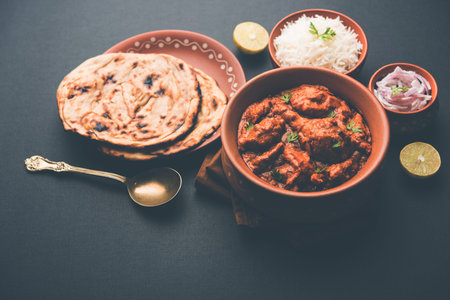 Murgh Makhani / Butter chicken tikka masala served with roti / Paratha and plain rice along with...