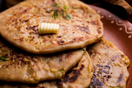 Aloo Paratha / Indian Potato stuffed Flatbread. Served with fresh curd and tomato ketchup. selective...