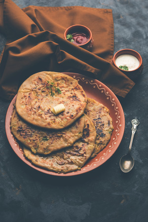Aloo Paratha / Indian Potato stuffed Flatbread. Served with fresh curd and tomato ketchup. selective focusの写真素材