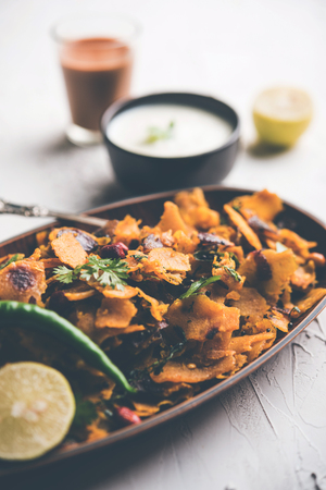 Homemade Kothu Parotta/ Paratha or Stir Fried Leftover Chapati Masala or  fodnichi poli in marathi, served in a bowl or plate with curd and hot tea. Selective focusの写真素材