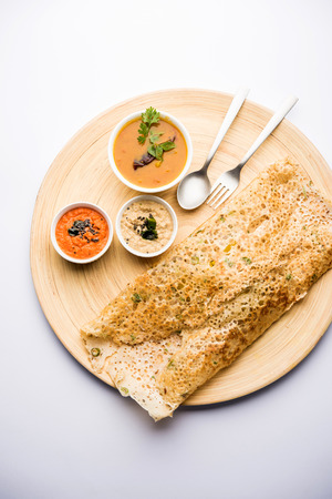 Onion rava masala dosa is a South Indian instant breakfast served with chutney and sambar over moody background. selective focusの写真素材