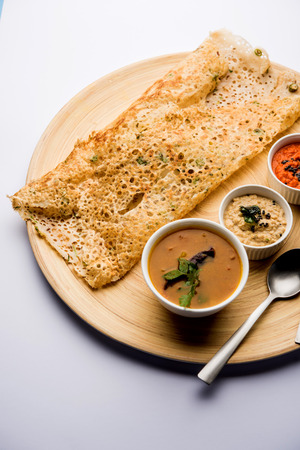 Onion rava masala dosa is a South Indian instant breakfast served with chutney and sambar over moody background. selective focusの写真素材