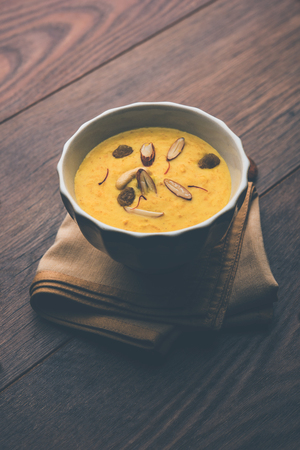 Kaddu or Pumpkin Kheer Or Bhoplyachi Kheer in Marathi and gummadikaya payasam in Telugu, Garnished with dry fruits. served in a bowl over moody background. Selective focusの写真素材