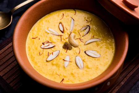 Kaddu or Pumpkin Kheer Or Bhoplyachi Kheer in Marathi and gummadikaya payasam in Telugu, Garnished with dry fruits. served in a bowl over moody background. Selective focusの写真素材