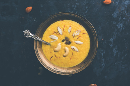 Kaddu or Pumpkin Kheer Or Bhoplyachi Kheer in Marathi and gummadikaya payasam in Telugu, Garnished with dry fruits. served in a bowl over moody background. Selective focusの写真素材
