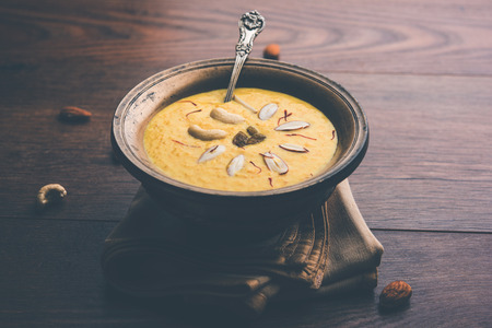 Kaddu or Pumpkin Kheer Or Bhoplyachi Kheer in Marathi and gummadikaya payasam in Telugu, Garnished with dry fruits. served in a bowl over moody background. Selective focusの写真素材