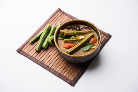 Drumstick Curry or Shevga sheng bhaji or south indian Sambar, served in a bowl over moody background. Selective focusの写真素材