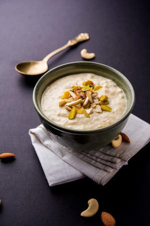 Sweet Rabdi or Lachha Rabri or basundi, made with pure milk garnished with dry fruits. Served in a bowl over moody background. Selective focusの写真素材
