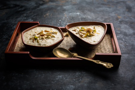 Sweet Rabdi or Lachha Rabri or basundi, made with pure milk garnished with dry fruits. Served in a bowl over moody background. Selective focusの写真素材