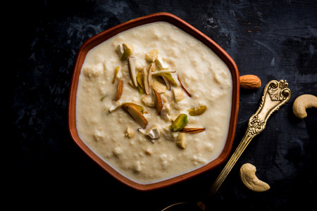 Sweet Rabdi or Lachha Rabri or basundi, made with pure milk garnished with dry fruits. Served in a bowl over moody background. Selective focusの写真素材