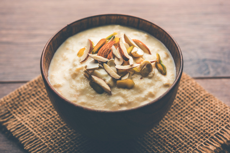 Sweet Rabdi or Lachha Rabri or basundi, made with pure milk garnished with dry fruits. Served in a bowl over moody background. Selective focusの写真素材