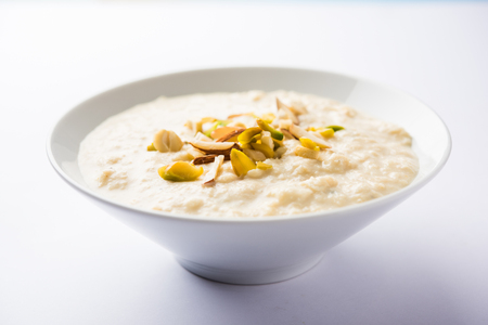 Sweet Rabdi or Lachha Rabri or basundi, made with pure milk garnished with dry fruits. Served in a bowl over moody background. Selective focusの写真素材