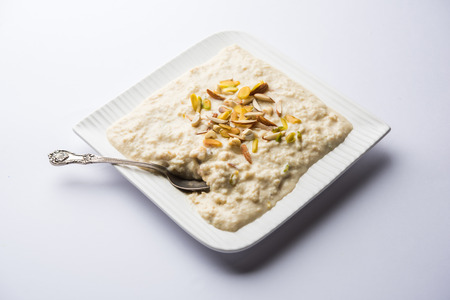 Sweet Rabdi or Lachha Rabri or basundi, made with pure milk garnished with dry fruits. Served in a bowl over moody background. Selective focusの写真素材