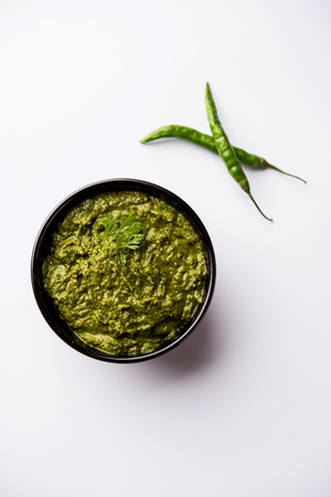 Healthy Indian Green Chutney or Sauce Made using Coriander, Mint And Spices. isolated over moody background. Selective focusの写真素材