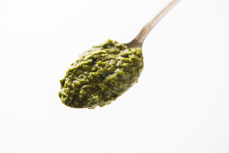 Healthy Indian Green Chutney or Sauce Made using Coriander, Mint And Spices. isolated over moody background. Selective focusの写真素材
