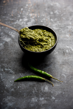 Healthy Indian Green Chutney or Sauce Made using Coriander, Mint And Spices. isolated over moody background. Selective focusの写真素材
