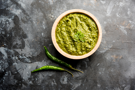 Healthy Indian Green Chutney or Sauce Made using Coriander, Mint And Spices. isolated over moody background. Selective focusの写真素材