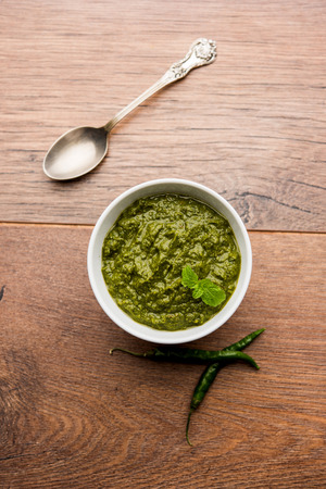 Healthy Indian Green Chutney or Sauce Made using Coriander, Mint And Spices. isolated over moody background. Selective focusの写真素材