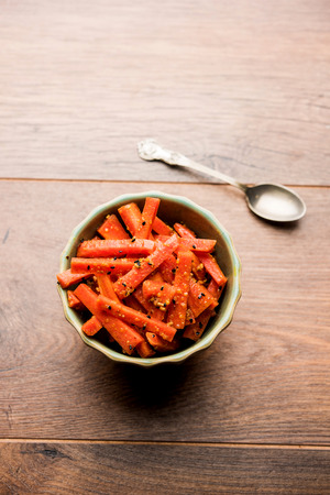 Carrot Pickle / Gajar ka Achar or Loncha in hindi. Served in a bowl over moody background. Selective focusの写真素材