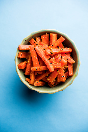 Carrot Pickle / Gajar ka Achar or Loncha in hindi. Served in a bowl over moody background. Selective focusの写真素材
